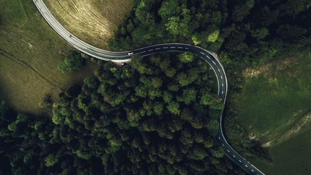Overhead view of car driving on a road 