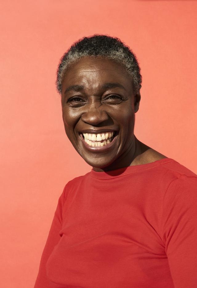 Smiling woman with orange background