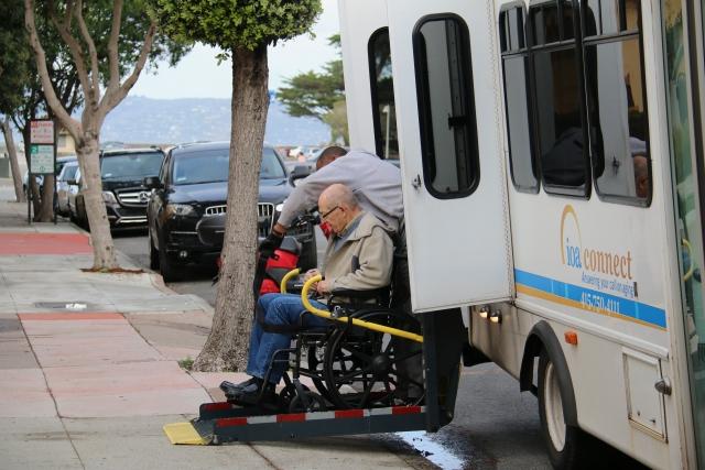 Member getting off of a bus in a wheelchair